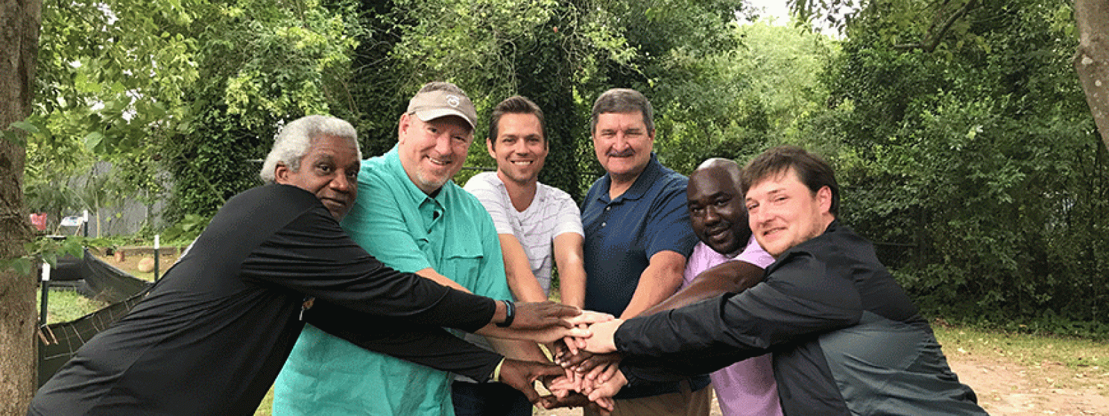A shepherd's heart: CIU alumnus Rob Settle (center, blue shirt), with some of the men of Providence Home. (Photo provided) 