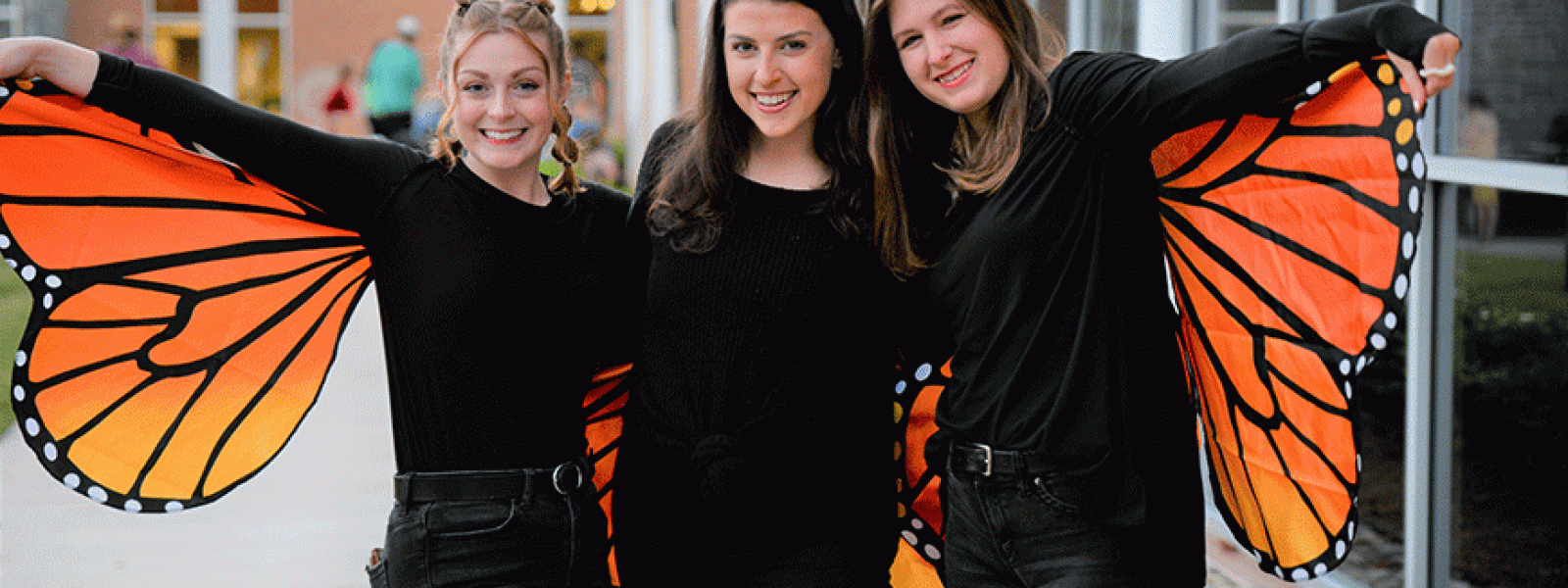 Bridgette Hollowell, Catie McGovern and Eliza Butler form a butterfly.