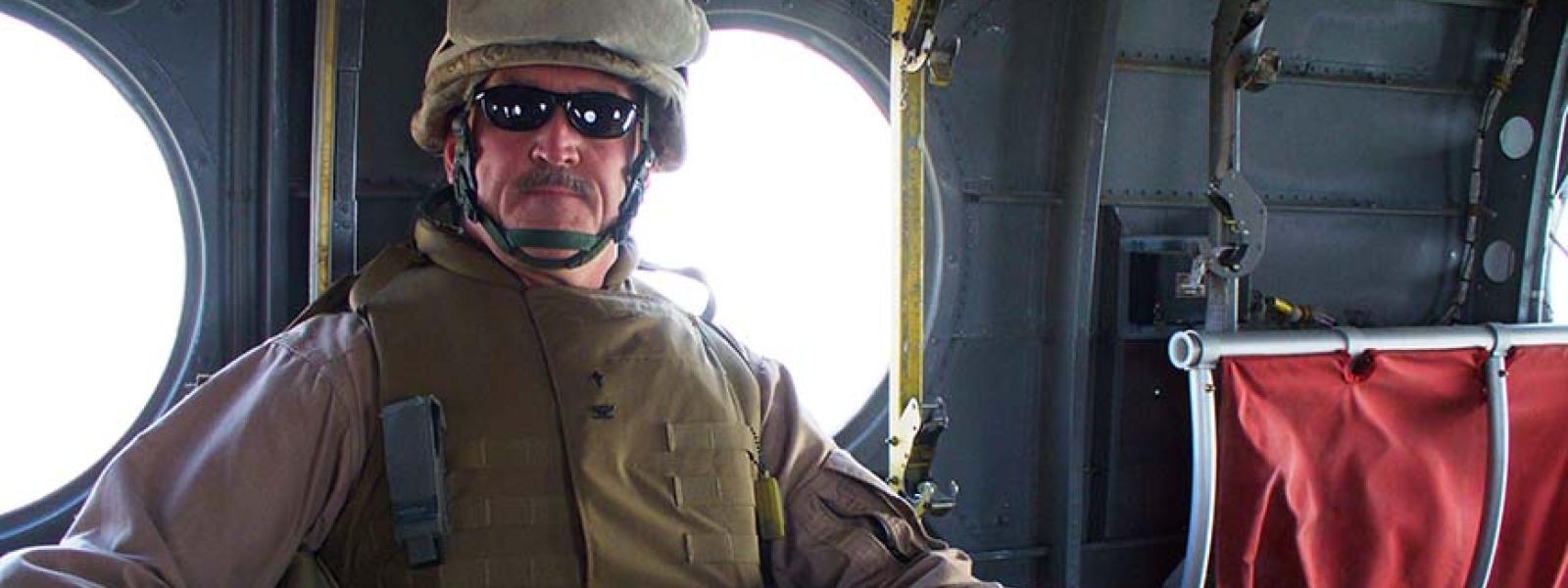 Dr. Mike Langston as a U.S. Navy chaplain in a helicopter over Afghanistan.