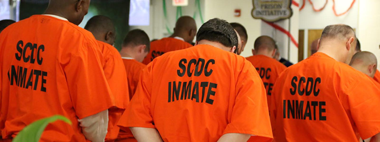 Students enrolled in the CIU Prison Initiative pray at a Prison Initiative commencement held at Kirkland Correctional Institution in Columbia. 