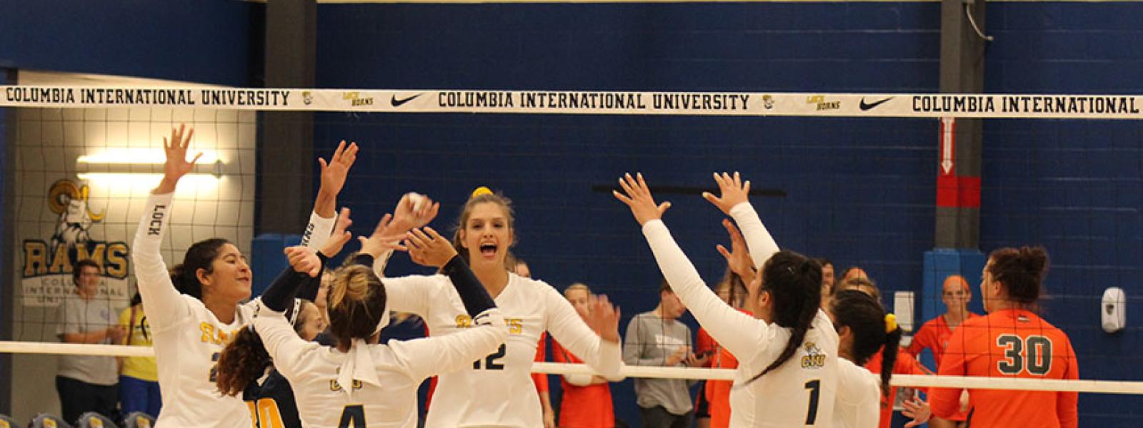 High fives all around on a big night for CIU volleyball. (Photos by Andrea Calamoro)