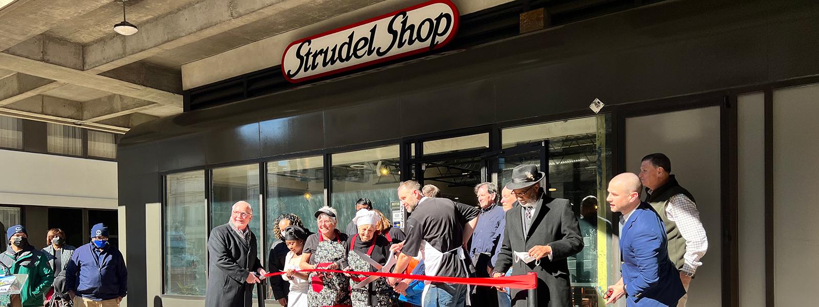 Cutting the ribbon on the opening of the Strudel Shop. (Photo by Meera Bhonsle, Cola Daily)