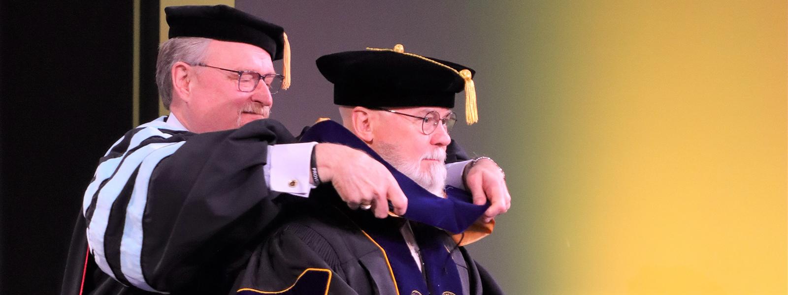 Tom Mullikin receiving his doctorate from CIU Executive Vice President Dr. Rick Christman 