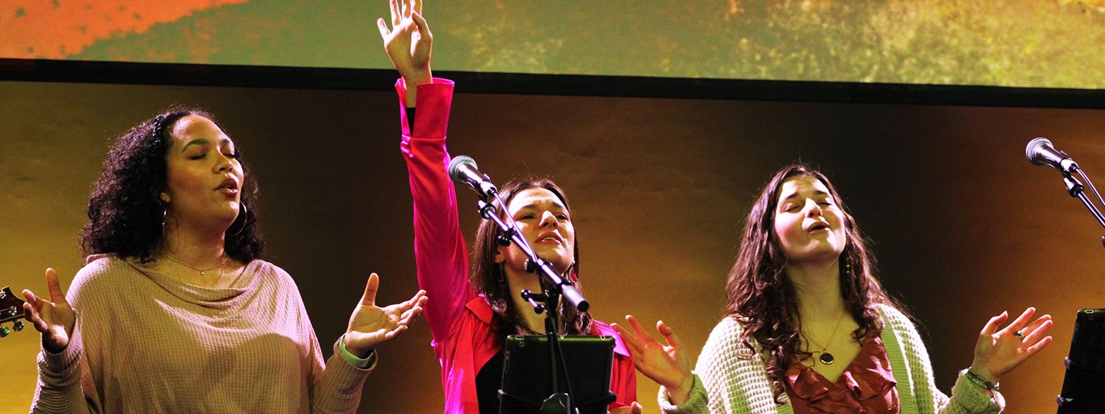 Jada Stroud, Sara Harrington and Mary Hockenberry lead in worship. (Photo by Andrea Calamaro, CIU Student Photographer)