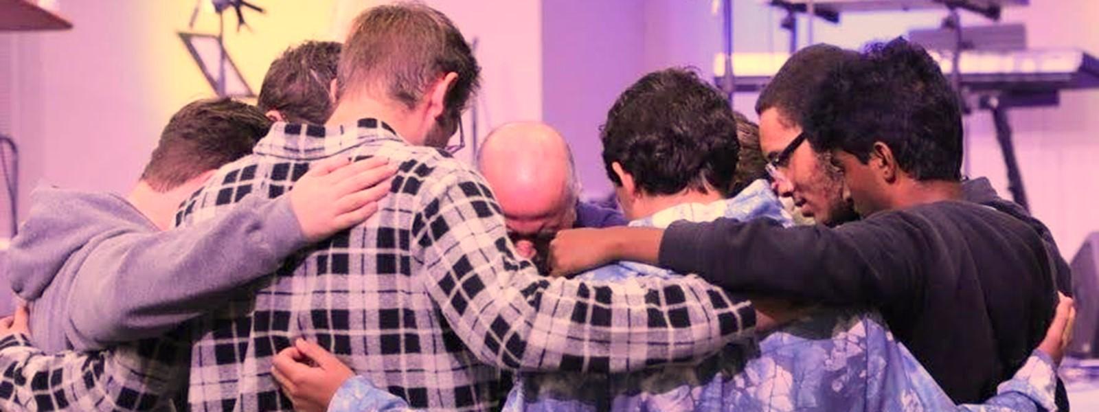 A group of CIU men pray for world evangelization. (Photo by Chariti Mealing, CIU student photographer)