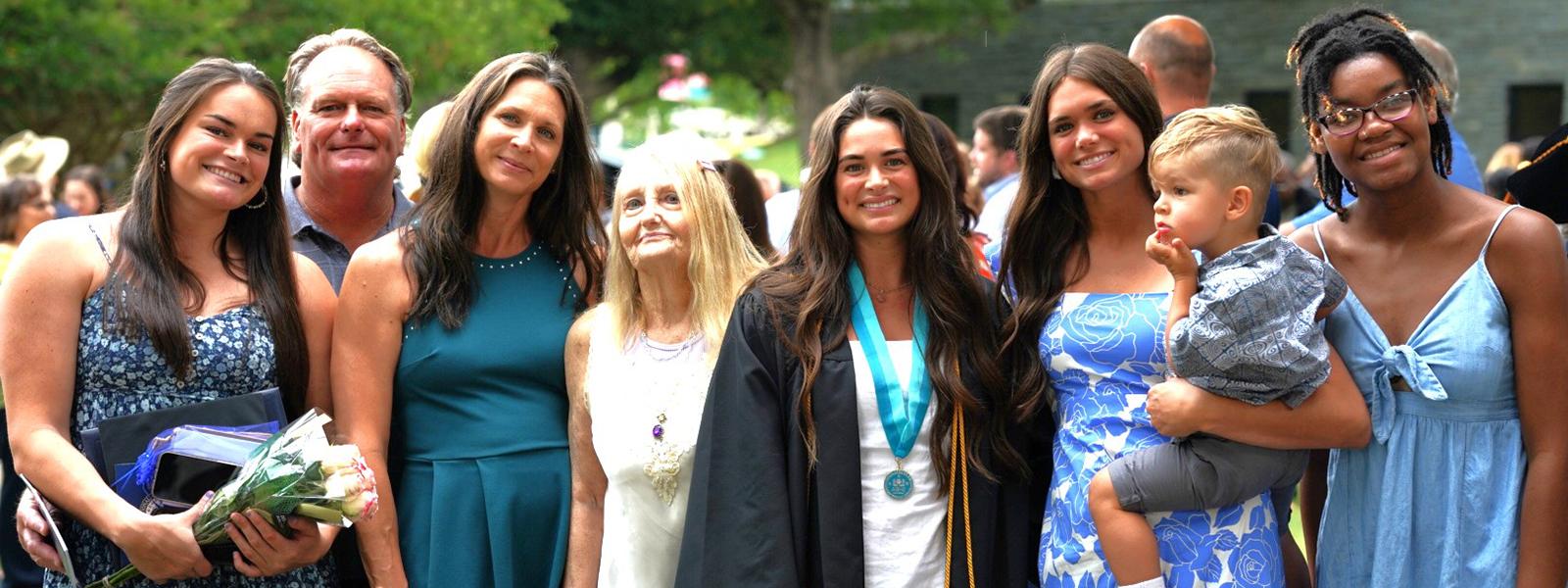 Brianna North (in middle wearing Delta Epsilon Chi Honor Society medal) poses with family. (Photo by Noah Allard)  