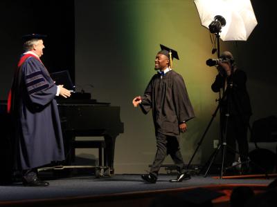 Justin Belk being congratulated by CIU President Dr. Mark Smith. 