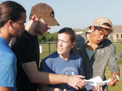 CIU students Josh Will, Darian Hair, Erin Gobbi and Caleb Joung react to Amazing Race instructions.