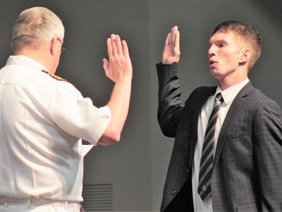 Caleb McKillop takes the oath with the assistance of CIU Professor Dr. Mike Langston, a former Navy chaplain.