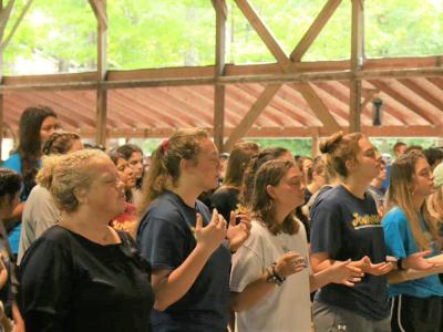 Athletes and coaches worship in song at the retreat 