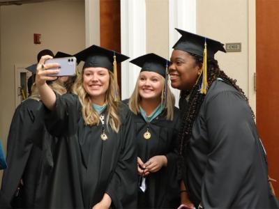 Three CIU students celebrate graduation. 