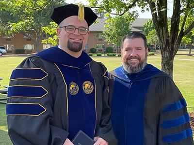 Dr. Josh Waltman (left) celebrates with Dr. David Croteau, the dean of Columbia Biblical Seminary at CIU.