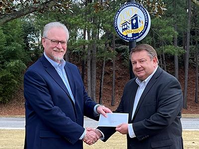 Jeff McCormack (right) delivers a check for $50,000 to CIU Acting President Dr. Rick Christman in December. 