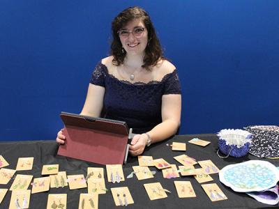 CIU senior Andrea Calamaro displays earrings and cloth pouches from her business Whymsical Butterflies.  (Photos by Ashley Tripp and Victoria Wheat)  