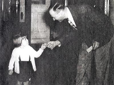 wo-year-old Alleen Petty hands CIU's first president R.C. McQuilkin a silver dollar in 1948 on the school's 25th anniversary.  