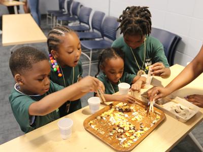 "A Bird Beak Buffet." Students from the Carolina School for Inquiry learn how the shape of a beak can determine what a bird eats. (Photo by Bob Holmes)