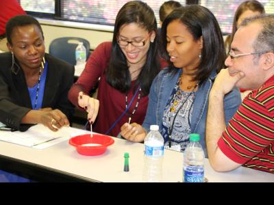 Christian school educators conduct an experiment at a session on "Teaching for Inquiry." 